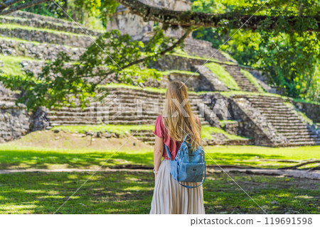 Female tourist exploring the ancient pyramids of Palenque, Mexico, surrounded by dense jungle. Cultural heritage and adventure travel concept Female tourist exploring the ancient pyramids of Palenque, Mexico, surrounded by dense jungle. Cultural heritage and adventure travel concept 119691598