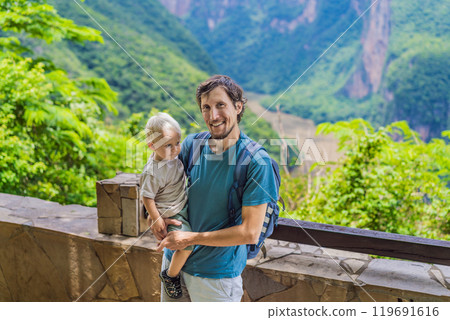 Dad and his baby son travelers exploring Sumidero Canyon National Park, Mexico. Adventure, natural exploration, and travel experience concept Dad and his baby son travelers exploring Sumidero Canyon National Park, Mexico. Adventure, natural exploration, and travel experience concept 119691616