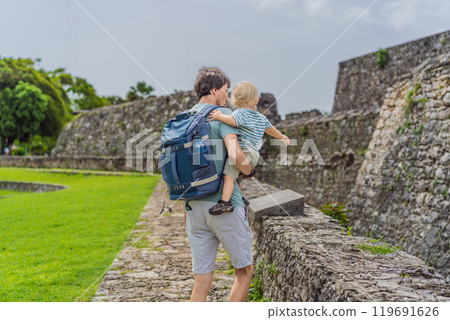 Father with his toddler son exploring Fuerte de San Felipe de Bacalar. Family travel, cultural heritage, and historical adventure concept 119691626