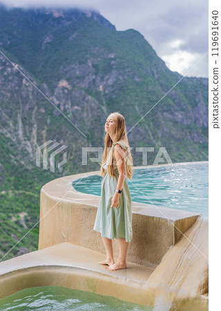 Female tourist at the hot springs of Grutas Tolantongo, Mexico. Adventure, relaxation, and natural wellness concept Female tourist at the hot springs of Grutas Tolantongo, Mexico. Adventure, relaxation, and natural wellness concept 119691640