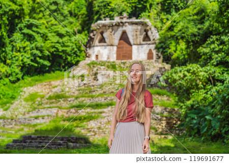Female tourist exploring the ancient pyramids of Palenque, Mexico, surrounded by dense jungle. Cultural heritage and adventure travel concept 119691677
