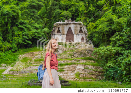 Female tourist exploring the ancient pyramids of Palenque, Mexico, surrounded by dense jungle. Cultural heritage and adventure travel concept 119691717