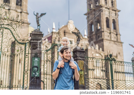Father and son tourists in front of Catedral de Puebla, Mexico. Travel, cultural heritage, and historic architecture exploration concept Father and son tourists in front of Catedral de Puebla, Mexico. Travel, cultural heritage, and historic architecture exploration concept 119691741