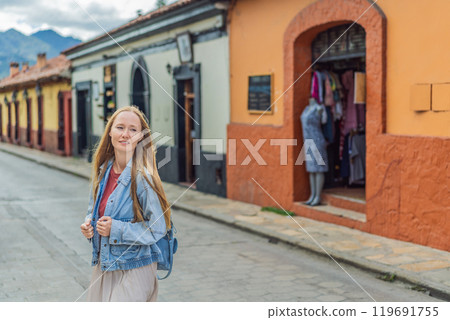 Female tourist walks through the colonial streets San Cristobal de las Casas, Mexico. Cultural exploration, architecture, and travel experience concept 119691755