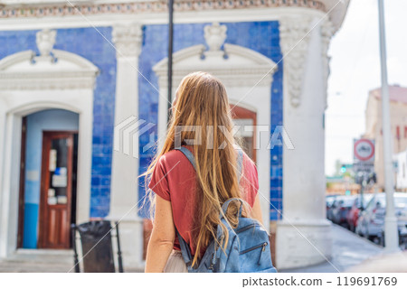 Female tourist in front of Casa de los Azulejos in Villahermosa, Mexico. Quintana Roo travel, cultural exploration, and historic architecture concept Female tourist in front of Casa de los Azulejos in Villahermosa, Mexico. Quintana Roo travel, cultural exploration, and historic architecture concept 119691769
