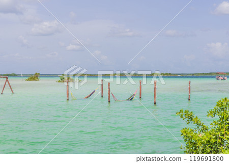 Turquoise waters of Bacalar Lake, Mexico. Peaceful and scenic tropical destination. Travel, relaxation, and nature concept 119691800
