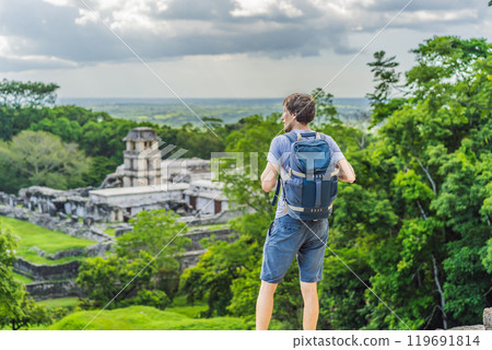 Man tourist exploring the ancient pyramids of Palenque, Mexico, surrounded by dense jungle. Cultural heritage and adventure travel concept Man tourist exploring the ancient pyramids of Palenque, Mexico, surrounded by dense jungle. Cultural heritage and adventure travel concept 119691814