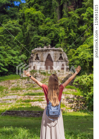 Female tourist exploring the ancient pyramids of Palenque, Mexico, surrounded by dense jungle. Cultural heritage and adventure travel concept 119691815