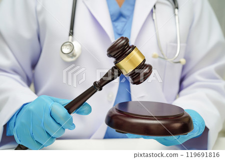 Doctor holding judge gavel, forensic medicine, medical law and crime justice. Doctor holding judge gavel, forensic medicine, medical law and crime justice. 119691816