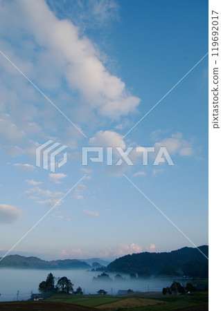 Background material: Rural landscape with morning mist, blue sky and white clouds, copy space 119692017