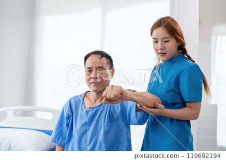 Young Caregiver Assisting Elderly Patient in Modern Healthcare Facility, Demonstrating Compassionate Care and Support in a Bright, Clean Environment Young Caregiver Assisting Elderly Patient in Modern Healthcare Facility, Demonstrating Compassionate Care and Support in a Bright, Clean Environment 119692194
