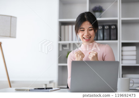 Young Female Student Delighted with Test Score While Studying Online, Celebrating Success in Modern Home Office, E-Learning Achievement, Happy Academic Moment, Remote Education, Digital Learning Young Female Student Delighted with Test Score While Studying Online, Celebrating Success in Modern Home Office, E-Learning Achievement, Happy Academic Moment, Remote Education, Digital Learning 119692473