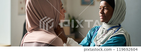 Muslim Female Doctor Examining Patient in Office Setting Muslim Female Doctor Examining Patient in Office Setting 119692604