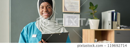 Smiling Muslim Medical Professional Holding Clipboard 119692714