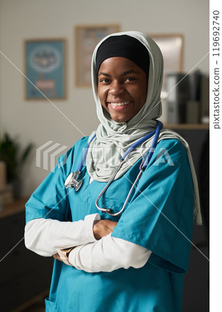 Smiling Muslim Nurse Wearing Scrubs in Medical Office Smiling Muslim Nurse Wearing Scrubs in Medical Office 119692740