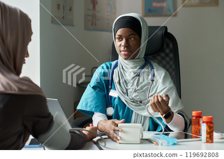 Muslim Healthcare Professional Checking Blood Pressure in Clinic 119692808