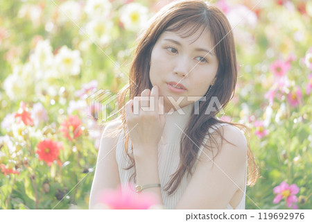 A woman surrounded by flowers 119692976