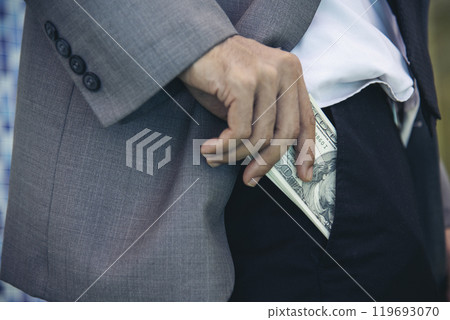 Hand holding money dollar bank note in wallet give financial payment. Man hands showing spread 100 dollar exchange cash in wallet. Saving Businessman counting money banknote bribe corruption concept. 119693070