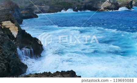 Turquoise ocean sea water white wave splashing deep blue sea. Bird eye view monster wave splash on rock. Tropical sea beach in summer seaside outdoor. Ocean island beautiful dramatic landscape. 119693088