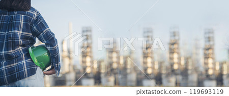 Banner Woman worker hands holding hardhat yellow work helmet Construction Engineer. Panorama Refinery woman worker industry hand hold yellow worker helmet hard hat. Refinery industry with copy space 119693119