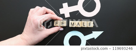 Hand takes away part of world Female between genders symbols 119693246