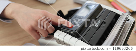 Finger of accountant pushing button to start bill counter 119693266