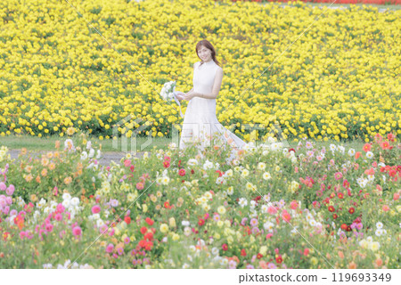 A woman happily strolling through a flower field 119693349