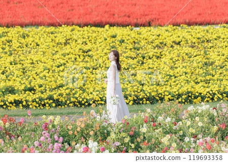 A woman happily strolling through a flower field 119693358