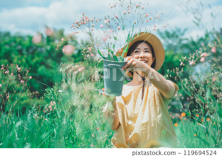 A woman picking saponaria in a flower field A woman picking saponaria in a flower field 119694524