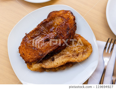 Fried bread with milk, egg and sugar. Typical Spanish Easter sweet Fried bread with milk, egg and sugar. Typical Spanish Easter sweet 119694927