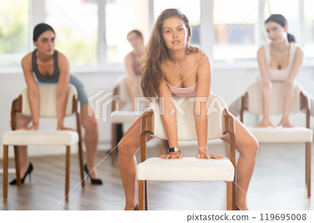 Beautiful graceful chair dance class practice at wall and window hall 119695008