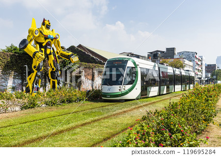 The circular light rail train drives past Pier-2 Art Center in Kaohsiung, Taiwan. 119695284