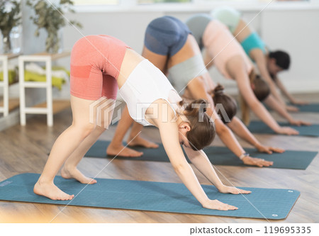 Women meditates in yoga pose parshvottanasana in gym 119695335