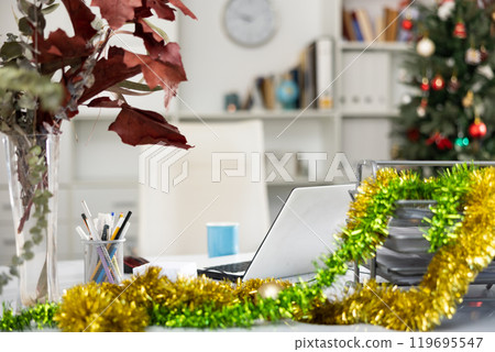 Table in office with laptop and Christmas decorations 119695547