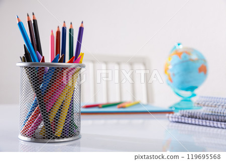 Concept of preparation for school. Different school supplies on the table 119695568