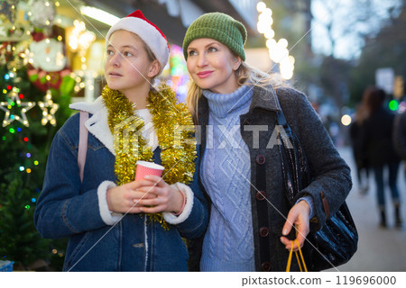Portrait of mother with daughter at christmas street fair Portrait of mother with daughter at christmas street fair 119696000