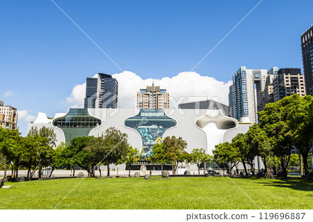 The large area of park space in front of the National Taichung Theater in Taiwan and the landscape of modern buildings on both sides. 119696887