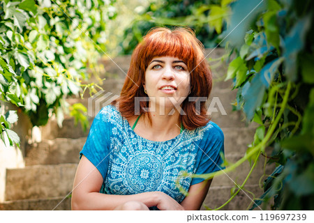 The girl with the red hair in the leaves 119697239