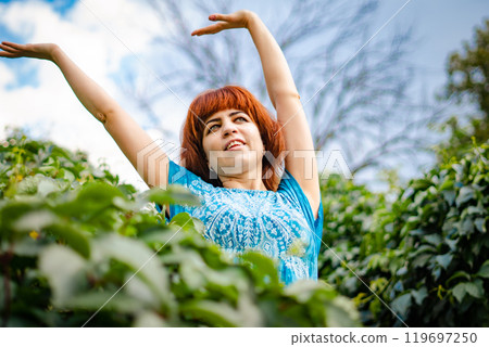 The girl with the red hair in the leaves The girl with the red hair in the leaves 119697250