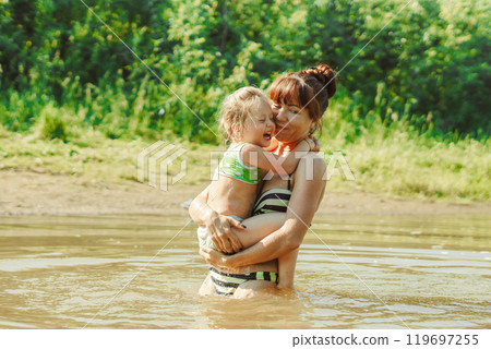 mom and child swim in the river mom and child swim in the river 119697255