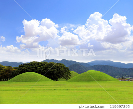 Grave hill for king of Silla Kingdom, Gyeongju, South Korea. Famous royal tombs in Cheonmachong park. Landmark of Gyeongju - burial mounds at Tumuli Park, Gyeongsangbuk-do, Republic of Korea Grave hill for king of Silla Kingdom, Gyeongju, South Korea. Famous royal tombs in Cheonmachong park. Landmark of Gyeongju - burial mounds at Tumuli Park, Gyeongsangbuk-do, Republic of Korea 119697295