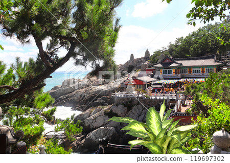Pavilions of Haedong Yonggungsa temple and Three-story pagoda on a rocky seashore, Busan, South Korea. Sea sceneries with Haedong Yonggung temple with ancient stone pagoda 119697302