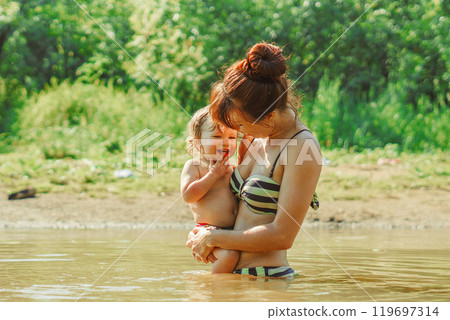 mom and child swim in the river mom and child swim in the river 119697314