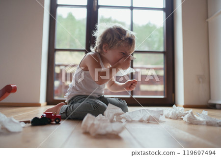 Sick boy with cold has stuffy nose and blowing his nose. Sick boy with cold has stuffy nose and blowing his nose. 119697494