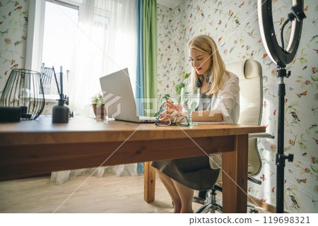 professional practicing public speaking skills using a setup with ring light for clarity and professionalism, blogger with laptop professional practicing public speaking skills using a setup with ring light for clarity and professionalism, blogger with laptop 119698321