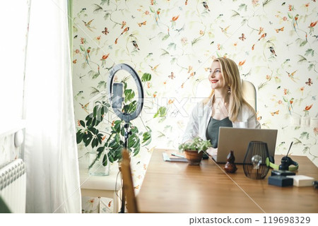 blogger recording a session for social media, emphasizing engagement and follower interaction with ring lamp, smartphone 119698329