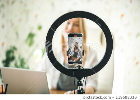 coach or influencer recording content with professional light and phone, creating a personal connection with viewers on blog coach or influencer recording content with professional light and phone, creating a personal connection with viewers on blog 119698330