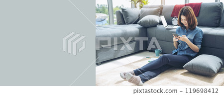 Banner Women sitting on sofa using smartphone, credit card to shopping online with smiling face shopaholics. Panorama Happy asian women lay down use smartphone. Woman online shopping with copy space Banner Women sitting on sofa using smartphone, credit card to shopping online with smiling face shopaholics. Panorama Happy asian women lay down use smartphone. Woman online shopping with copy space 119698412