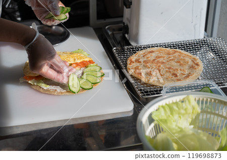 Chef prepares flatbread with salmon. Quesadilla. Chef prepares flatbread with salmon. Quesadilla. 119698873