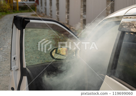 Smoke is coming from inside the car.  119699060